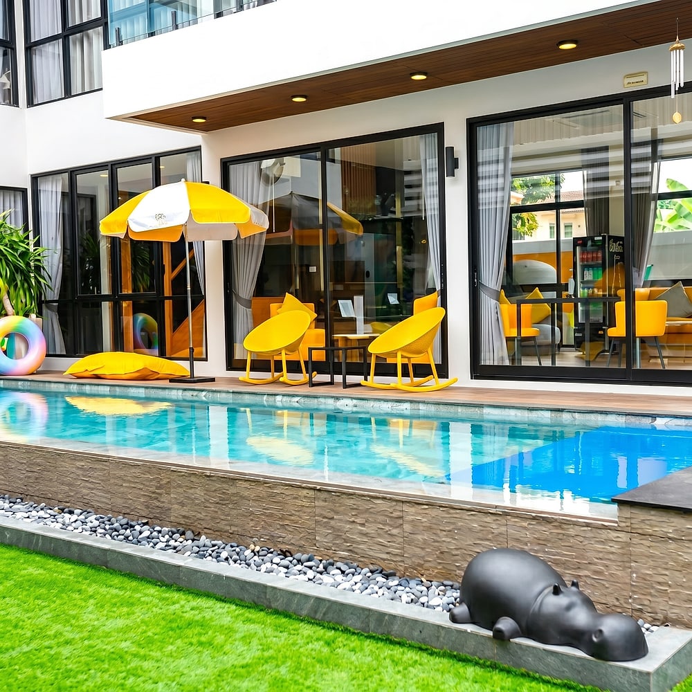 The pool with loungers and lawn